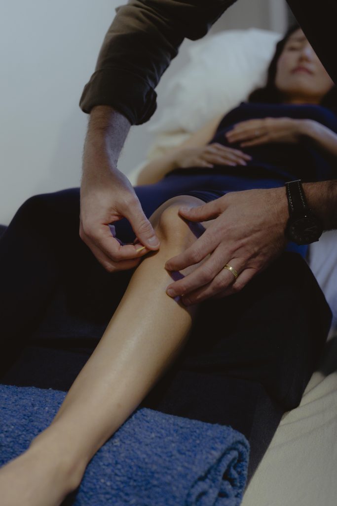 Vincent performing treatment on knee of patient